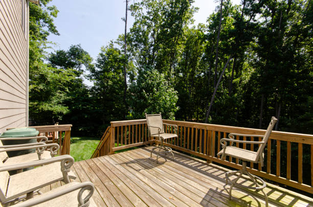 istock Wooden Deck With Chairs Facing Towards Lush Forest View 2182740109