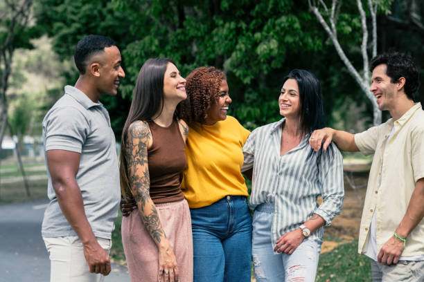 istock Small group of people having conversations outdoors in the sun 2182740772