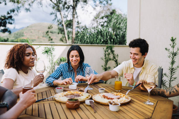 istock Small group of people having a meal together in a rooftop 2182740797