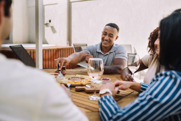 istock Small group of people having a meal together in a rooftop 2182740828