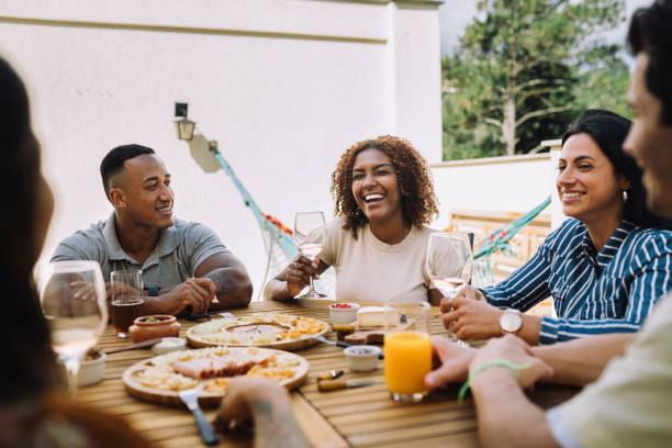 istock Small group of people having a meal together in a rooftop 2182740830