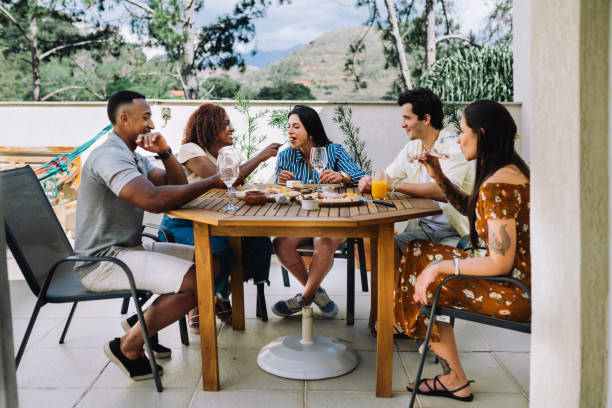 istock Small group of people having a meal together in a rooftop 2182740850