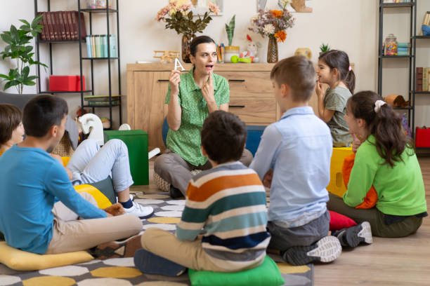 istock Group speech therapy lesson with an alphabet card 2182742731