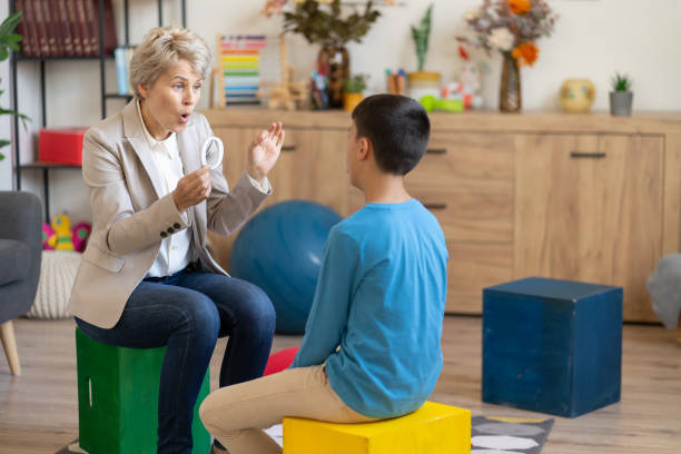 istock Speech therapy session with boy and letter 