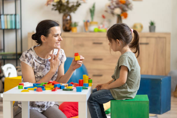 istock Educator and girl engaging with colored blocks 2182742753