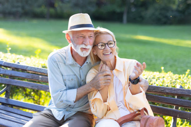 istock Elderly couple sharing joy and affection on park bench 2182743377