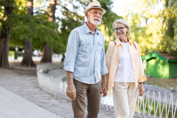istock Elderly couple joyfully strolling hand in hand by the pond 2182743403
