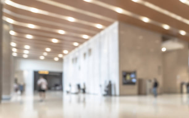 istock Blurred office building lobby or hotel blur background interior view toward reception hall, modern luxury lounge, white room space with blurry corridor and building glass wall 2182743442