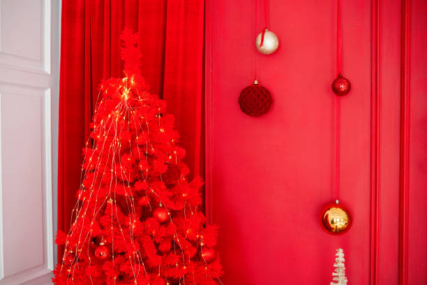 istock A vibrant red Christmas tree adorned with ornaments in a festive room 2182745055