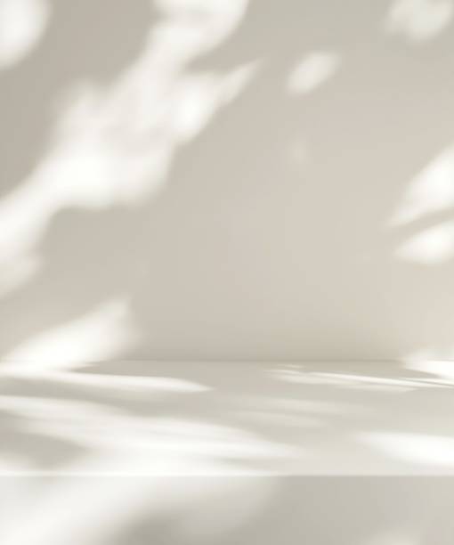 istock Modern, minimal empty cream white counter table top in dappled sunlight, leaf foliage shadow on wall for luxury organic fashion, beauty, cosmetic, skincare, body care product display background 3D 2182752627