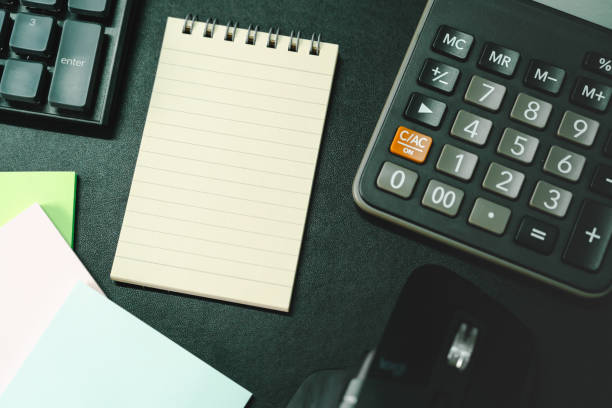 istock notepad on office desk table with keyboard and other supplies. 2182754524