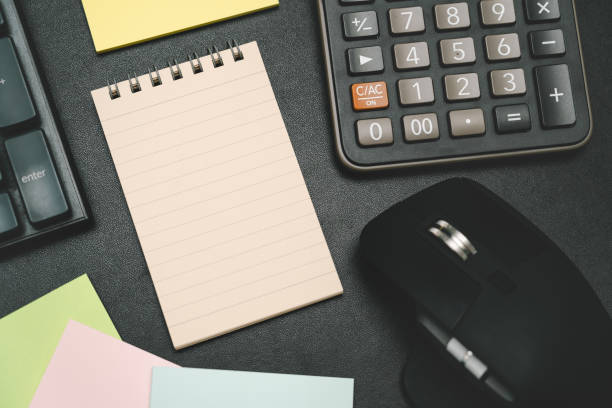 istock notepad on office desk table with keyboard and other supplies. 2182754554