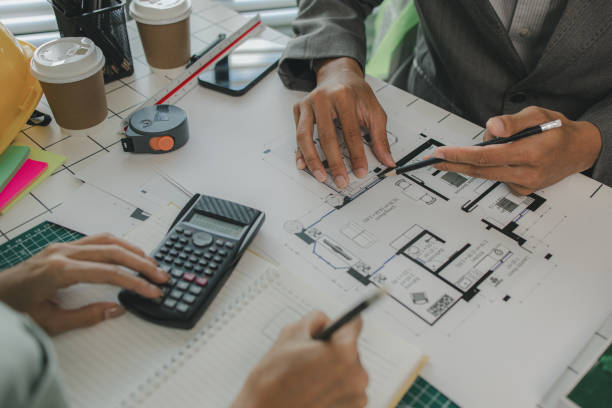 istock an architect and his assistant are brainstorming and examining the blueprints, two engineers are discussing a construction plan to make the structure stronger, draft, meeting, teamwork 2182755018