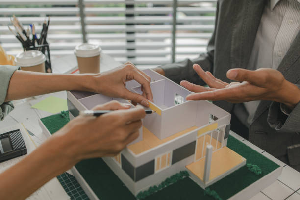 istock a foreman is consulting with an engineer about house structure, n architect and assistant are brainstorming and examining the blueprints, meeting, project, discussion, teamwork 2182755124