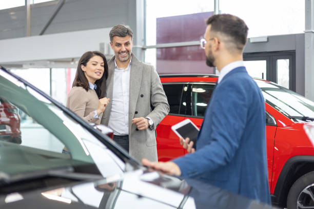 istock Enthusiastic couple looking at cars 2182757462