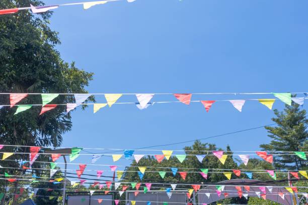 istock The colorful flags between the trees at a celebration event 2182758790