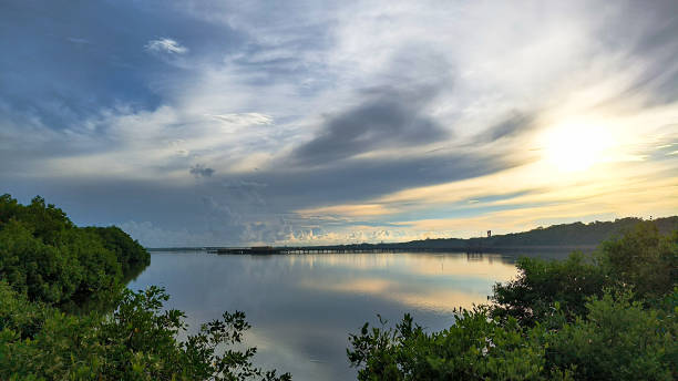 istock Serene Sunset over River Landscape with Vibrant Clouds and Reflections on Water Surface 2182761196