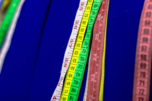 istock Colorful Measuring Tapes Draped Over a Blue Mannequin, Essential Tailoring and Sewing Tools for Accurate Measurements in Fashion Design 2182761317