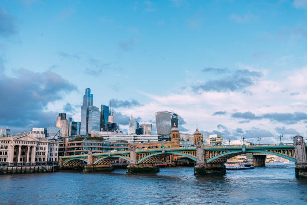 Southwark Bridge and Central London Skyline from the Thames Riverbank in the late afternoon