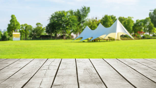 istock Empty wooden table top with tent camping blurred abstract scene 2182762263