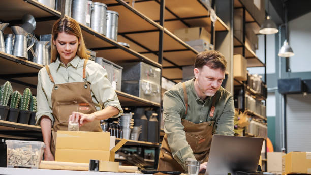 istock Two small business team members checking inventory and  packing new orders online for customer eco friendly brown paper wrapped with environmental Sustainability friendly  before shipping to customers ,zero waster and plastic free  quality control 2182765305