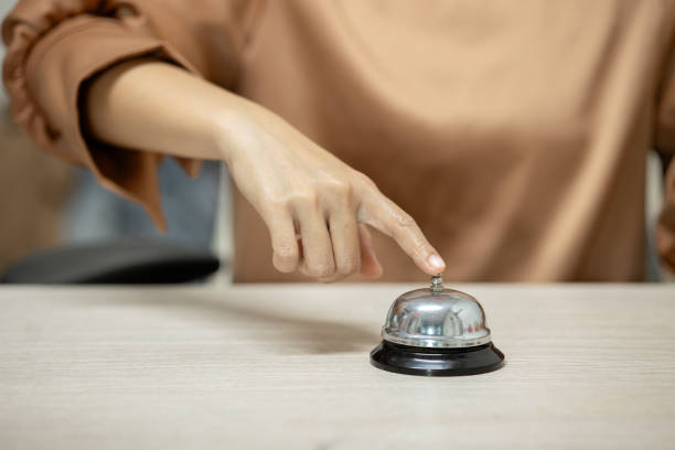istock A woman is pointing at a bell on a table 2182765853