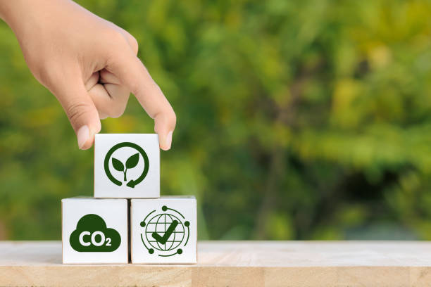 istock A hand is holding three white cubes with green symbols on them 2182766091