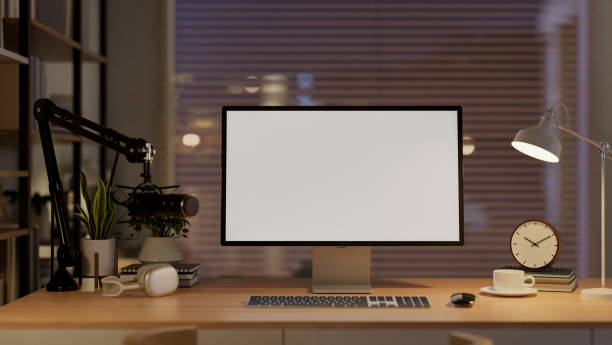 istock A contemporary home podcast office at night features a computer with a white screen mockup. 2182769205