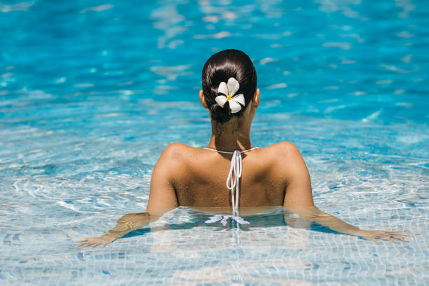 istock A woman swims in a pool enjoying the refreshing water. 2182774505