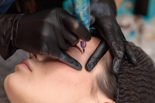 istock Cosmetologist applying permanent eyebrow makeup on woman 2182775964