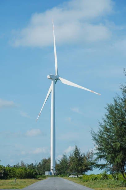 istock A large wind turbine for generating electricity using the force of the wind installed in an agricultural field against a blue sky. 2182776612