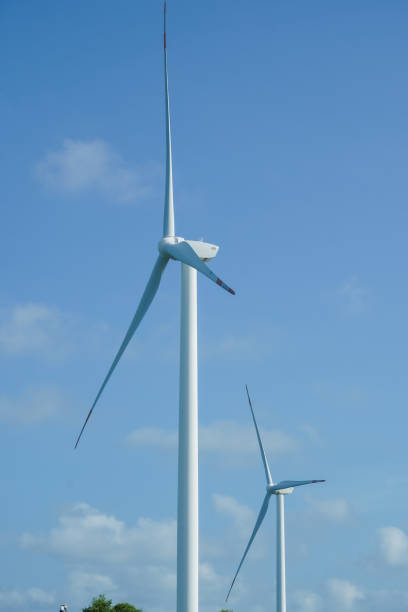 istock A large wind turbine for generating electricity using the force of the wind installed in an agricultural field against a blue sky. 2182776633