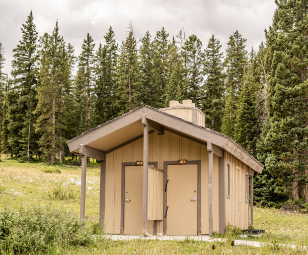 istock Public restroom facility in forested area of campground 2182777313