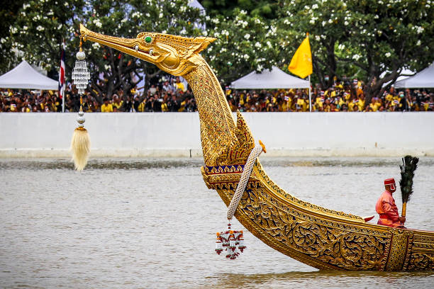 Bangkok, Thailand - October 27, 2024: Royal Kathin robe offering ceremony by royal barge procession at Wat Arun Ratchawararam with the royal barge Suphannahong sailing along the Chao Phraya River.