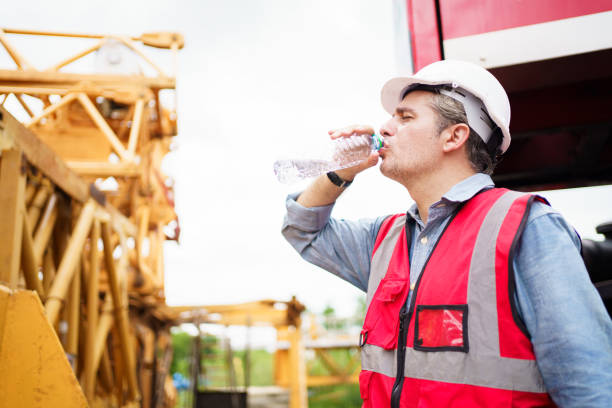 istock Thirsty and tired worker setting on the floor. 2182781431