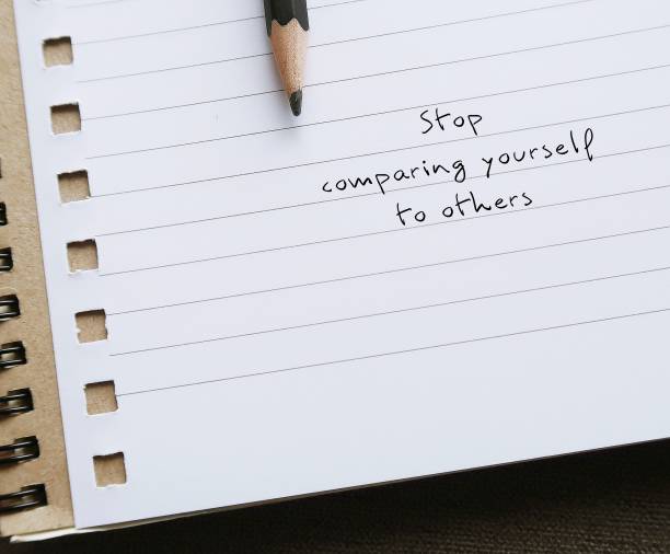 istock Notebook with handwritten text - Stop comparing yourself to others - concept of awareness to negative effects of the comparison trap which leads to negative and anxious thoughts 2182784329