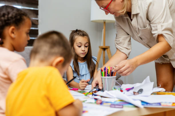 istock Children engaged in drawing at a classroom table. 2182785322