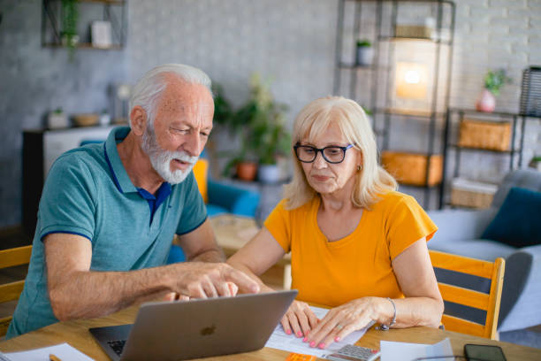 istock Senior couple using laptop while planning their home budget 2182785366