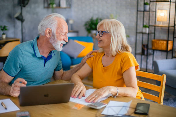istock Senior couple using laptop while planning their home budget 2182785709