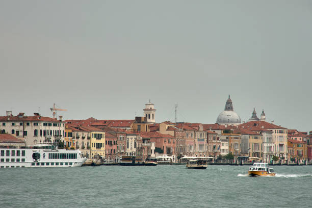 Venice,Italy;October,17,2024:the melancholic beauty of a Venetian canal on a cloudy day. Soft shadows from the overcast sky gently fall on the calm waters and historic buildings lining the canal, creating a serene and tranquil atmosphere