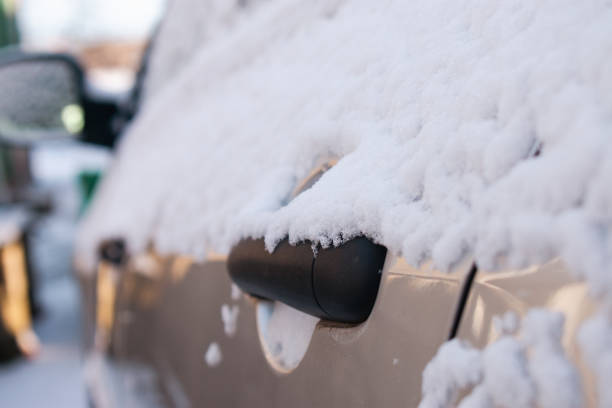 istock A grey car in the snow. Close-up 2182786237