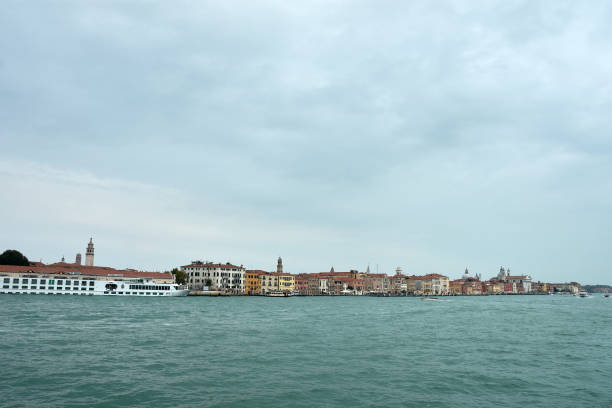 Venice,Italy;October,17,2024:the melancholic beauty of a Venetian canal on a cloudy day. Soft shadows from the overcast sky gently fall on the calm waters and historic buildings lining the canal, creating a serene and tranquil atmosphere