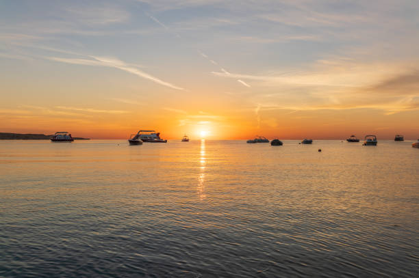 Sunrise over the sea. Panoramic seascape. Burning sky and shining golden waves. Sun over sea