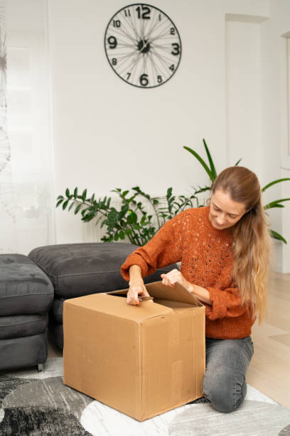 istock unpacking a large cardboard box 2182786634