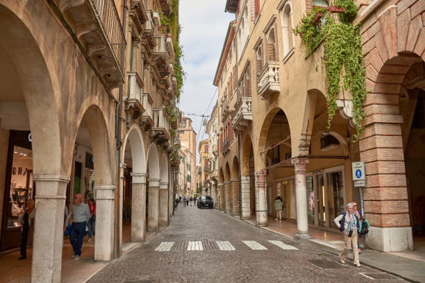 Treviso,Italia;October 14,2024:Calmaggiore is one of the main and most iconic streets in Treviso, Italy, known for its historic charm and vibrant atmosphere. This picturesque street, lined with elegant medieval and Renaissance buildings, leads from the Piazza del Duomo to Piazza dei Signori, offering a perfect blend of architecture, culture, and local life. Popular among locals and tourists, Calmaggiore is home to boutiques, cafés, and shops, making it a lively spot for exploration and leisure