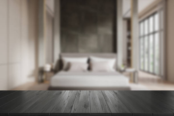 istock Wooden table mockup in front of blurred bedroom interior background. 3D Rendering 2182789067