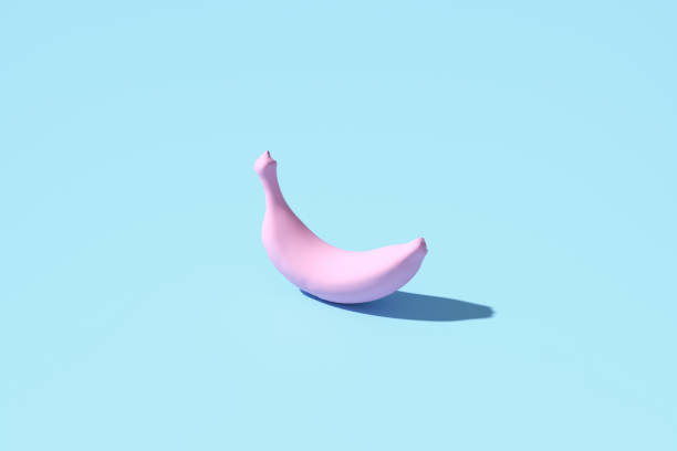 istock Pink banana casting shadow on pastel blue background 2182790137