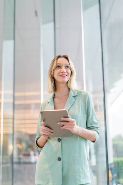 istock Caucasian Businesswoman Using Digital Tablet Inside a Modern Office Building 2182793830