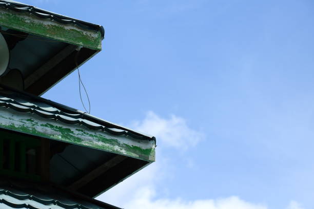 istock roof with clouds and clear sky in the background 2182794334