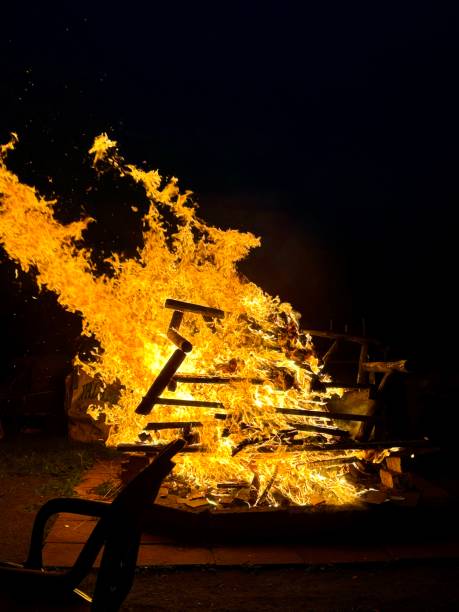Mysuru, Karnataka, India-January 14 2025; Flames from the Fire of haystack lit for the Bull run sport during Makar Sankranti religious festival in Mysore, India.